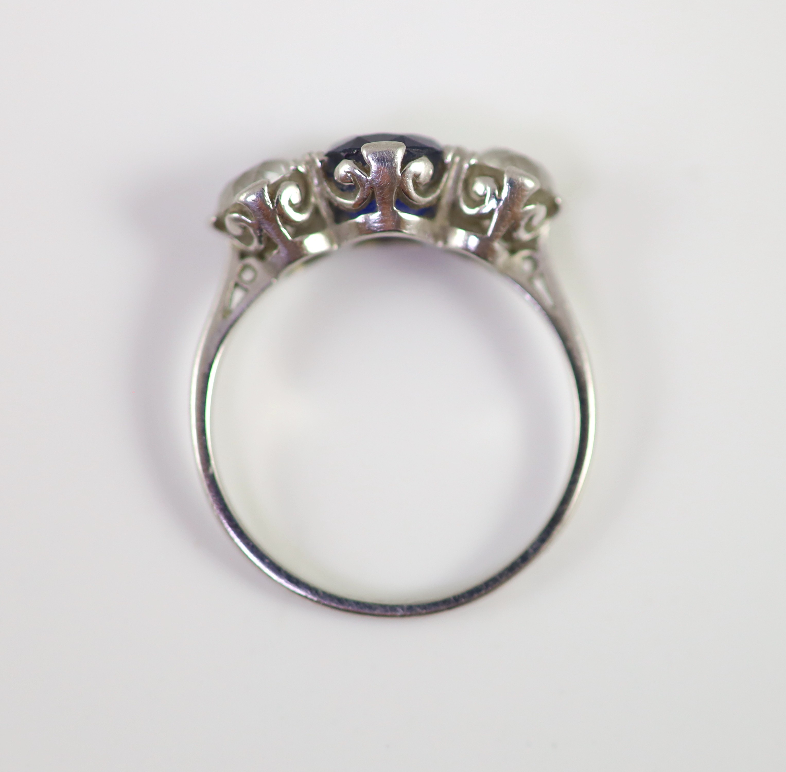 A platinum two stone diamond and single stone sapphire ring